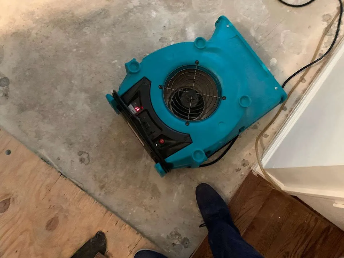 Air mover drying subfloor during Commercial Water Damage Restoration in Carol Stream